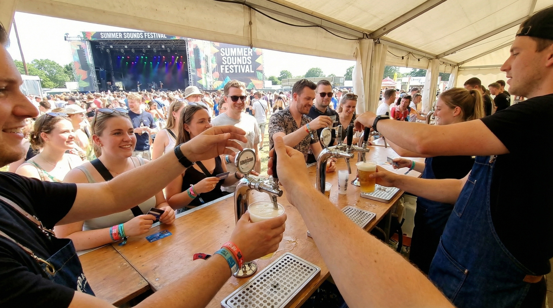 Festival beverage service with bartenders serving drinks to crowd